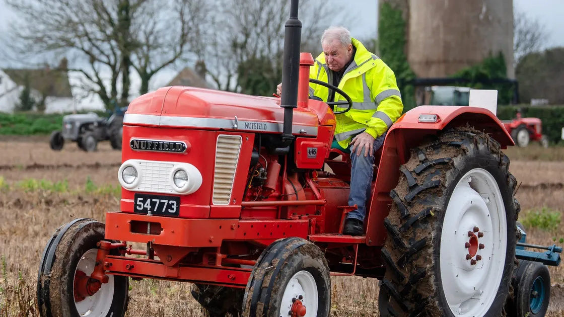 Ron Le Cras, driving a Nuffield, concentrates on keeping a straight line for his first furrow.