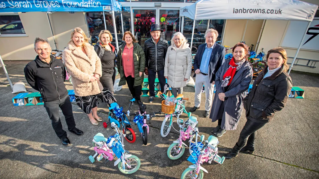 Kate and Vic Groves, fourth and third from right, at Ian Brown’s Cycle Shop with Sarah Groves Foundation trustee Peter Morrey, centre, and representatives from Social Services, Safer, HomeStart, Bright Beginnings and Ian Brown’s. (Picture by Sophie Rabey, 32822044)