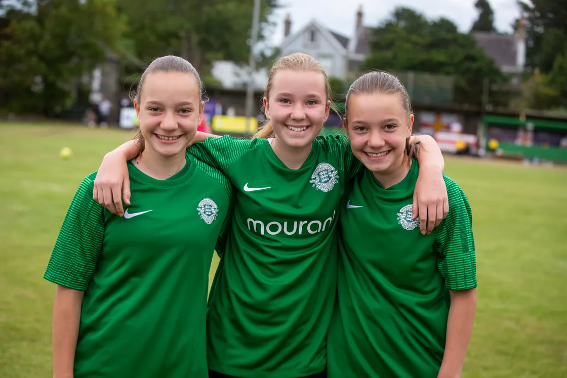 The girls, pictured here supporting Guernsey at the 2023 Island Games, started playing football in year three.