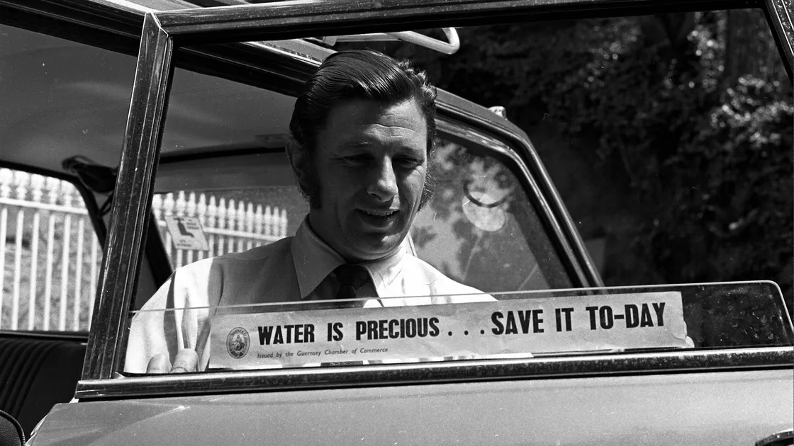 States Water Board president Deputy Roger Berry, pictured putting a sticker on his own car, praised islanders for taking on board the message to reduce water usage.