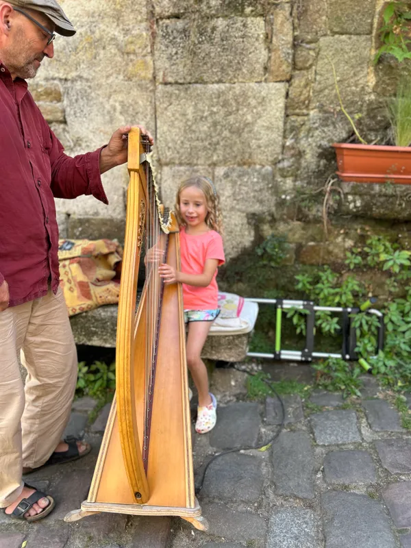 Megan tries her hand at playing the harp.