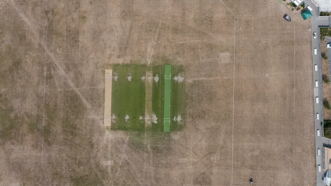 Peter Frankland’s drone photograph of the KGV playing fields shows the state of the cricket outfield baked by weeks and weeks of sunshine. Groundsman and former Island cricket captain, Stuart Le Prevost, said the weather was ideal for cricket – and he would do the best he could with his grass.