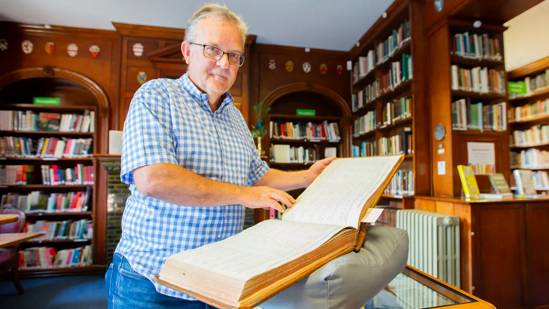 Priaulx Library chief executive Steve Foote with one of the registry books that have been digitally archived. (Picture by Karl Dorfner, 33473205)