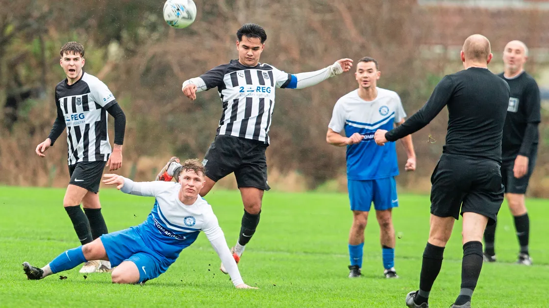Rovers midfielder Charlie Platt slides in on St Martin’s captain Jake Lowe on Saturday at Port Soif where Saints won 3-0. (Picture by Connor Rabey, 33917651)