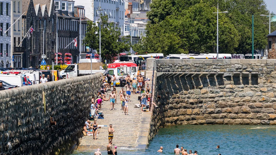 People raced to the beaches during last month's heatwave, or as in the case of this high tide, were jumping into the sea off the slipway at Havelet Bay. It brought the hottest-ever day in the island while the mean monthly temperature broke a record that had stood for 180 years. 				 (Picture by Sophie Rabey, 34807369)
