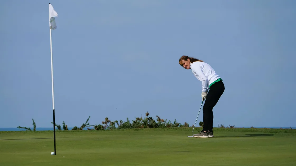 Sally Ingrouille holes a long putt in the 17th on her way to winning the last singles point.