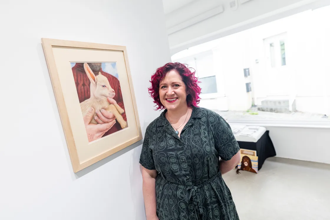 Lyndsey Longson’s portrait is of a baby goat cradled in the arms of its owner