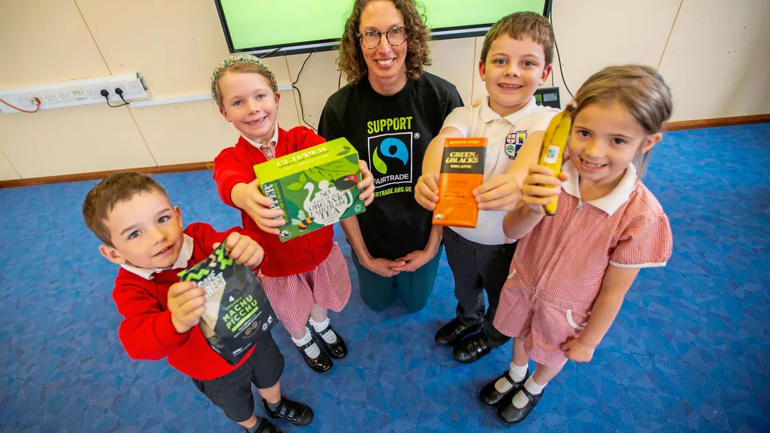 Hannah Davis from Fairtrade Guernsey visited Vale Primary School yesterday to hold an assembly to mark the start of Fairtrade Fortnight and celebrate 30 years of its products being on the shelves. Left to right, Leo Cunningham, Ciara Mitchell, both 5, Hannah Davis, Bailey Mallandaine and Beau Masterton, both 6. (Picture by Sophie Rabey, 33583877)