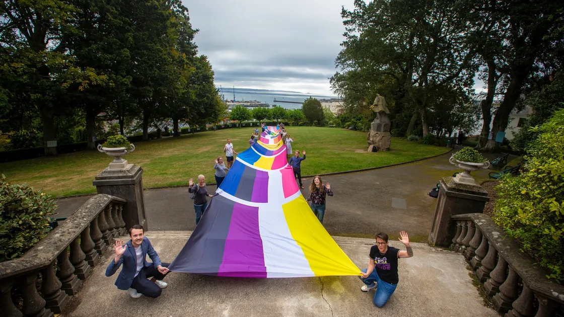 Holding the 50m-long flag at the front are Joseph Milward, from KPMG, which sponsored it, and Ellie Jones, CEO of Liberate and CI Pride director.(Pictures by Peter Frankland, 28671093)
