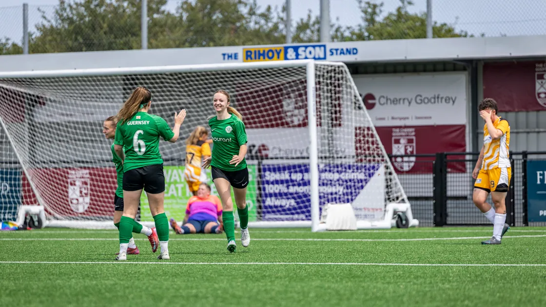 A smiling Heidi Dawber celebrates a goal with her Guernsey teammates as they clinched third place in the Cherry Godfrey Cup with a resounding 5-1 win over the Isle of Wight on Saturday.