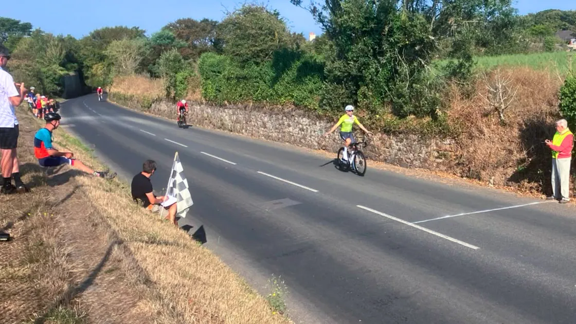 Thierry Le Cheminant starts to celebrate after opening up a gap in the sprint to the line in the men’s race.