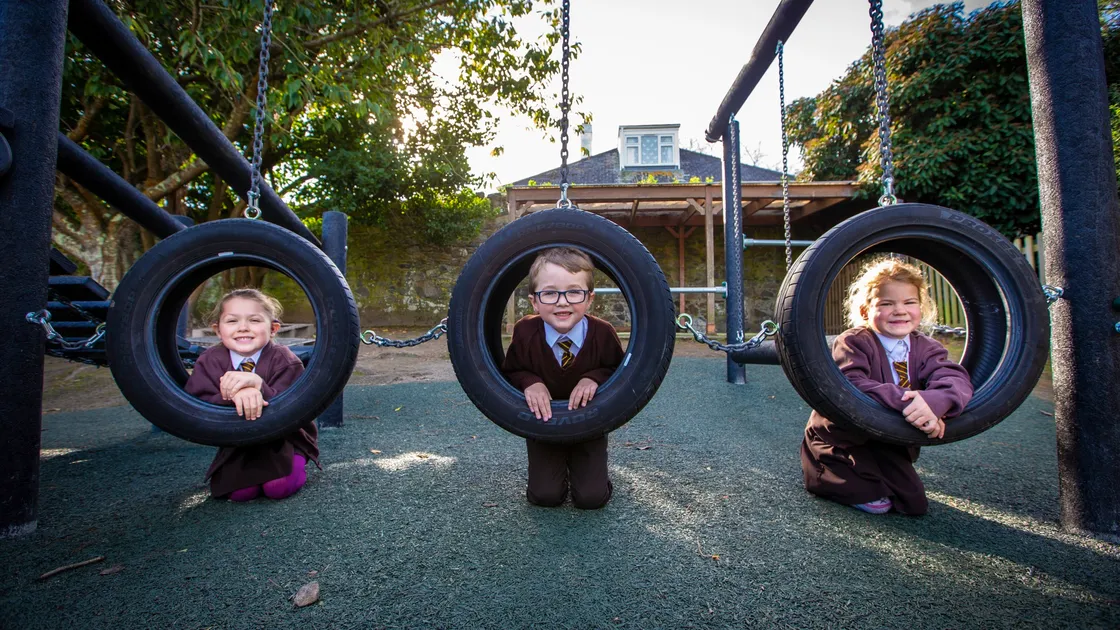 The tyres on which six-year-olds, left to right, Amelie Tadd, Harley Oliveira and Brooke Mathews are playing were once on the wheels of a forklift. In fact the whole of the new play equipment at St Mary & St Michael Primary School has been made from recycled materials.  (Pictures by Peter Frankland, 30166702)