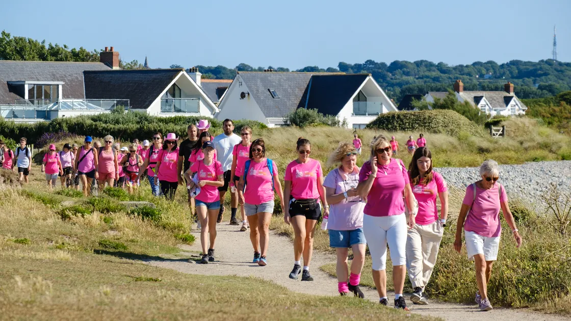 More than 1,500 people donned loud pink attire as they began their walk from either Grandes Rocques or Bordeaux and finished in Market Square in town on Saturday evening.