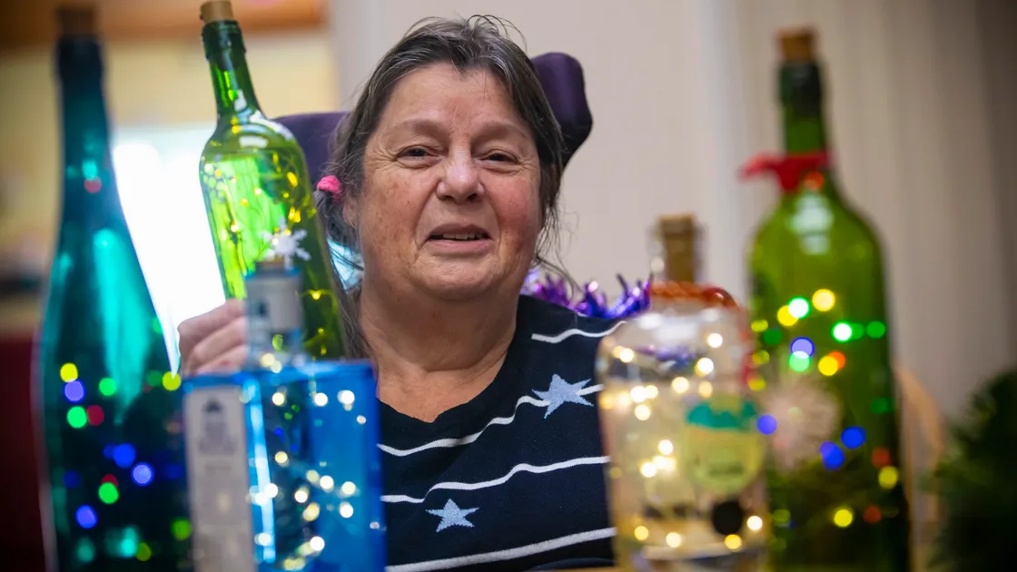 Rosie Le Maitre has made table decorations with lights out of old bottles. (Pictures by Peter Frankland, 26531432)