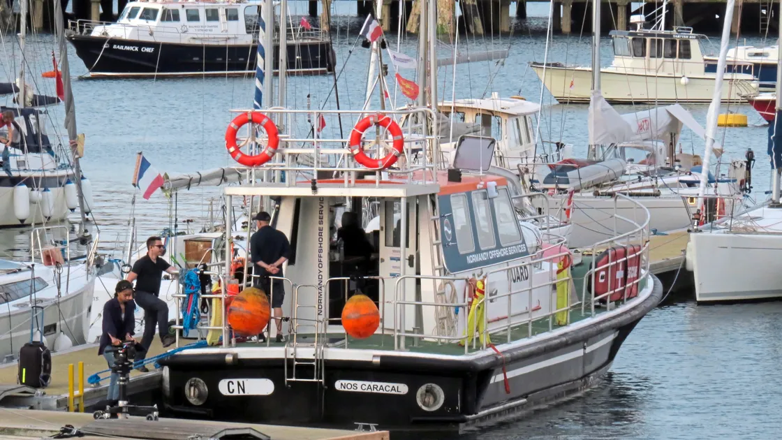 The film crew unloading equipment from the ex Pilot Cutter Nos Caracal in St Peter Port harbour.