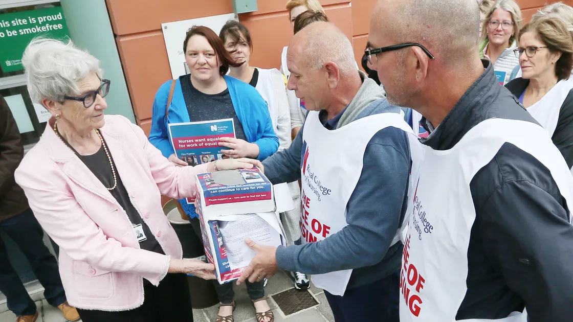 Royal College of Nursing branch chairman Steve Mundy hands a petition over to Policy & Resources member Deputy Jane Stephens outside Frossard House in August. (Picture by Adrian Miller, 26422794)