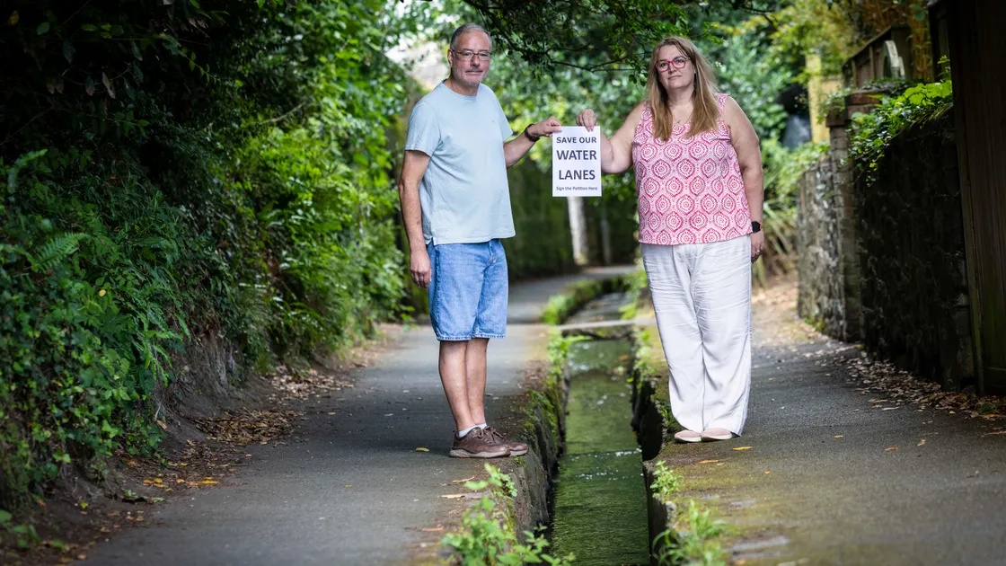 Darren and Natalie Davison of La Couture Inn pictured last July with the petition against the proposals to cover the stream in the Water Lanes to allow cyclists to use the area. 					 (Picture by Peter Frankland, 34653111)