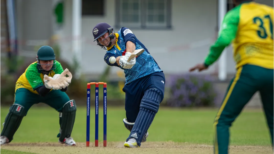 Josh Butler hits another boundary on his way to an unbeaten century for Cobo against Irregulars.