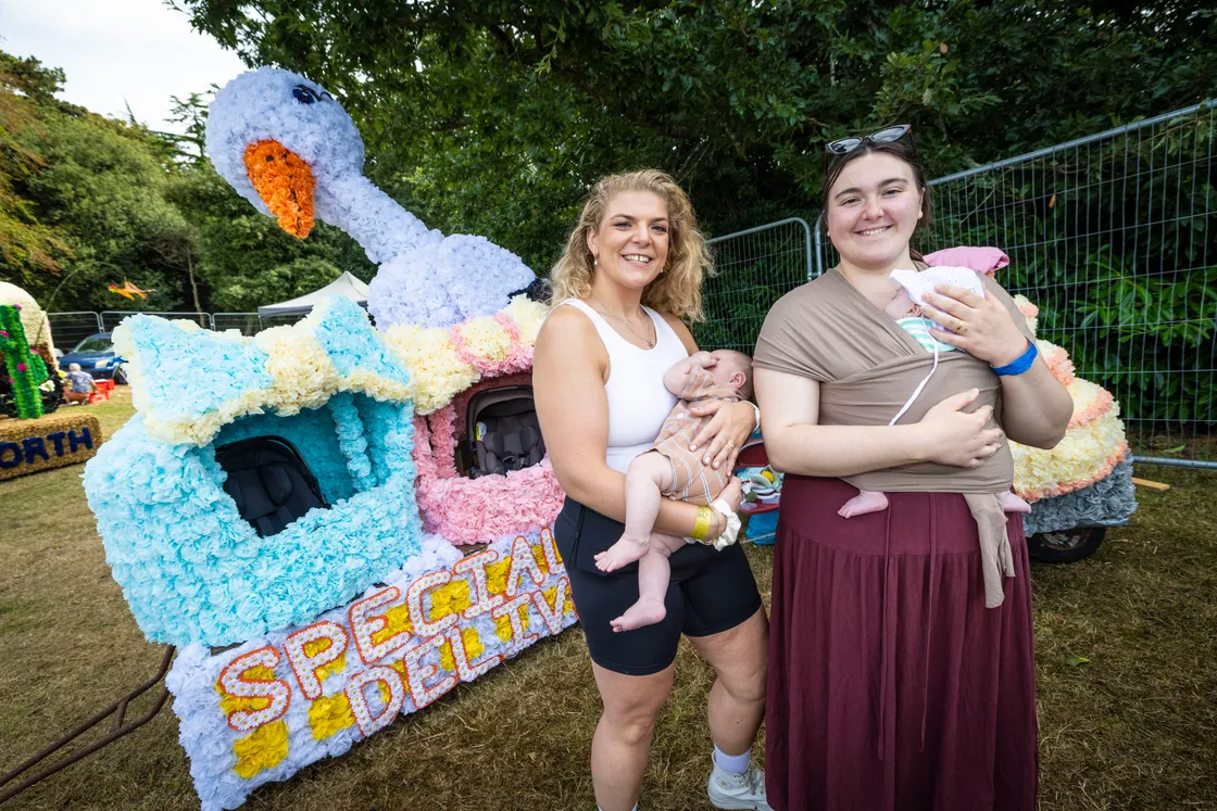 Beth Gabriel with her nephew Felix Cotran-Gabriel and Meredith Jee with her daughter Clara Jee and their float Special Delivery. 	