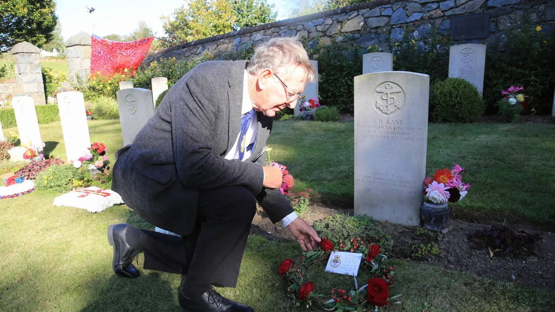 Pic by Adrian Miller 27-09-20 Foulon Cemetery. Remembrance service for H.M.S. Charybdis and H.M.S. Limbourne . Peter Carey member of the Charybdis and Limbourne Association lays a wreath.. (28735087)
