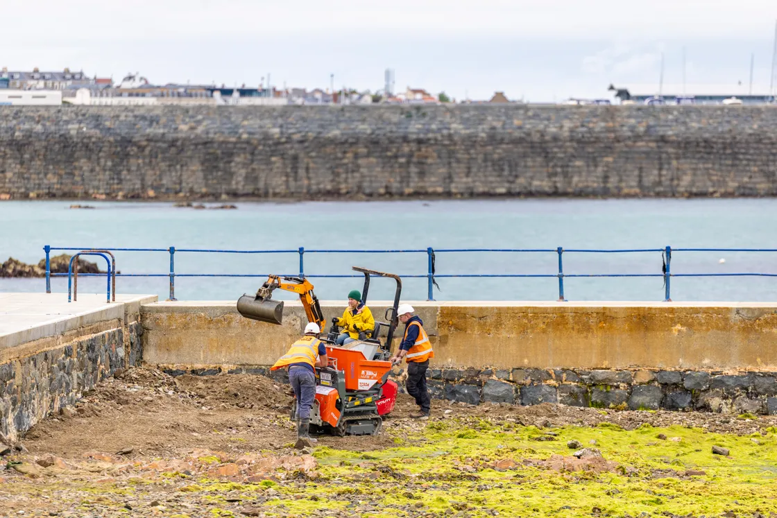 Small diggers and dumper trucks were craned into the pool at low water once it was drained.
