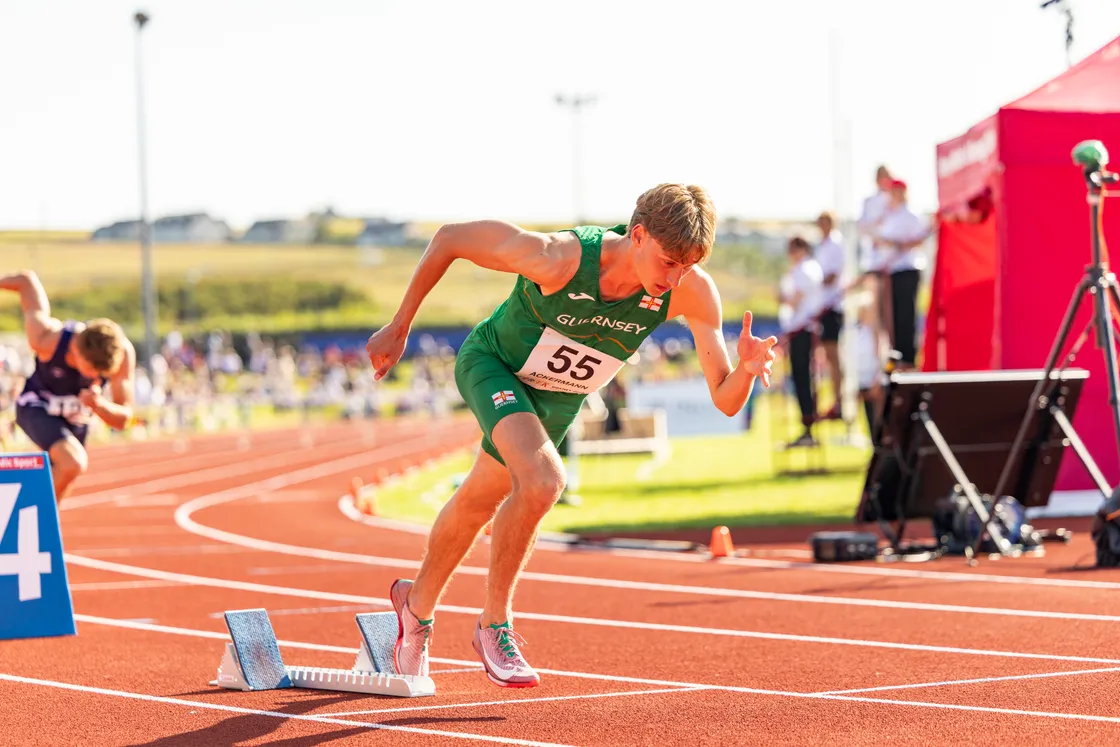 Nic Ackermann succeeded Alastair Chalmers, who helps coach him, as Island Games 400m hurdles champion.