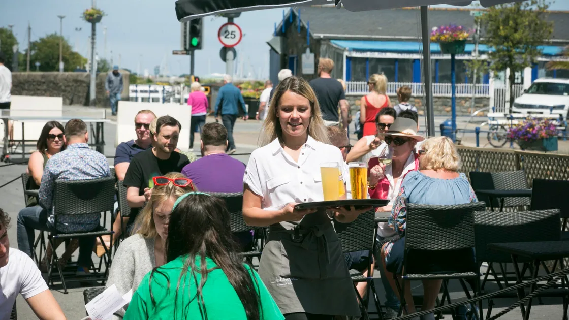 Balthazar assistant manager Erna Tamulynaite serves up some cold drinks at the Town Quay yesterday as al fresco dining returned in reduced form for Seafront Sunday.  (Picture by Adrian Miller, 28365777)