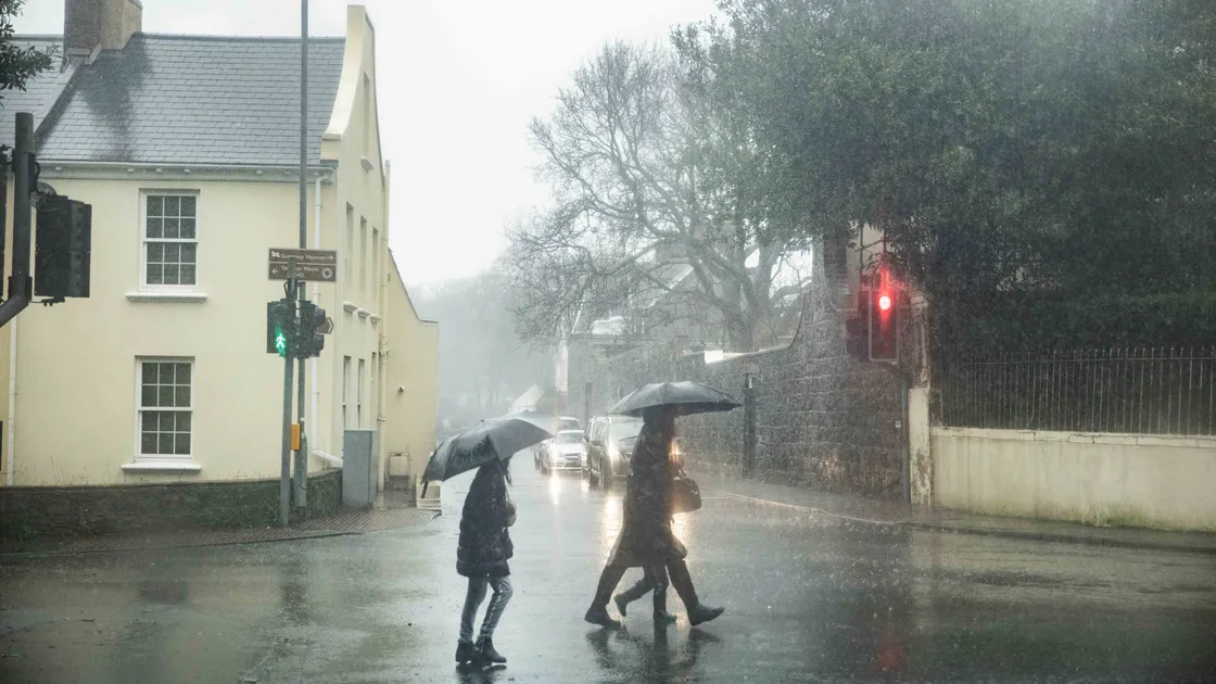 These people using the crossing at Elm Grove were caught in yesterday lunchtime’s downpour. (Pictures by Ben Fiore, 27189628)