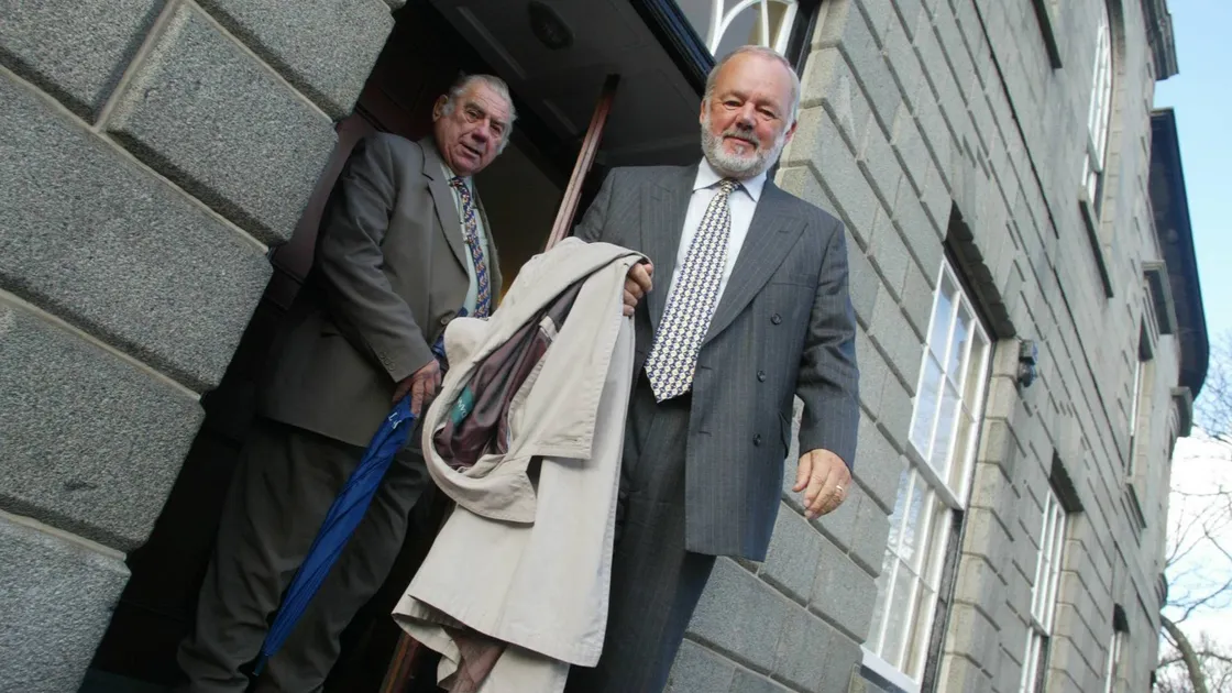 Brian Sheriff, right, pictured with the late Deputy Peter Bougourd, leaving a States meeting in 2003.