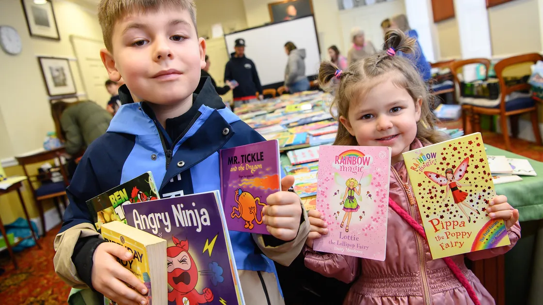 George Crowson, 6, and his sister Ella, 3, with books at the Soroptimist International Guernsey Big Book Giveaway held in the St Peter Port Constables' Office. Children of all ages were encouraged to seach the piles of books to select a few to take home to read. 				 (Picture by Andrew Le Poidevin 34656828)
