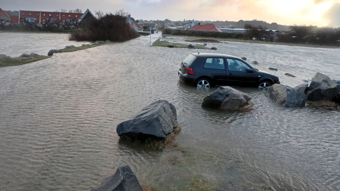 A car is stranded in flood water at Rue des Goddards, Vazon.   (Picture by Steve Sarre, 20288400)