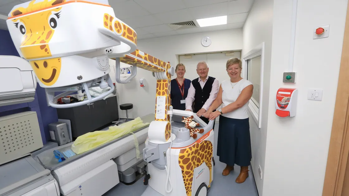 A donation of more than £100,000 from Steve and Maggie Lansdown has enabled the Princess Elizabeth Hospital to buy a new x-ray machine. As it looked like a giraffe, it has been decorated as one and named Lara. Pictured with the Lansdowns is lead radiographer Linda Gardner, left. (Picture by Adrian Miller, 29036411)