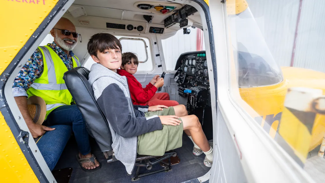 Having a go in Aurigny's historic Joey are Manu and Finn Herivel, aged 12 and 8. 	