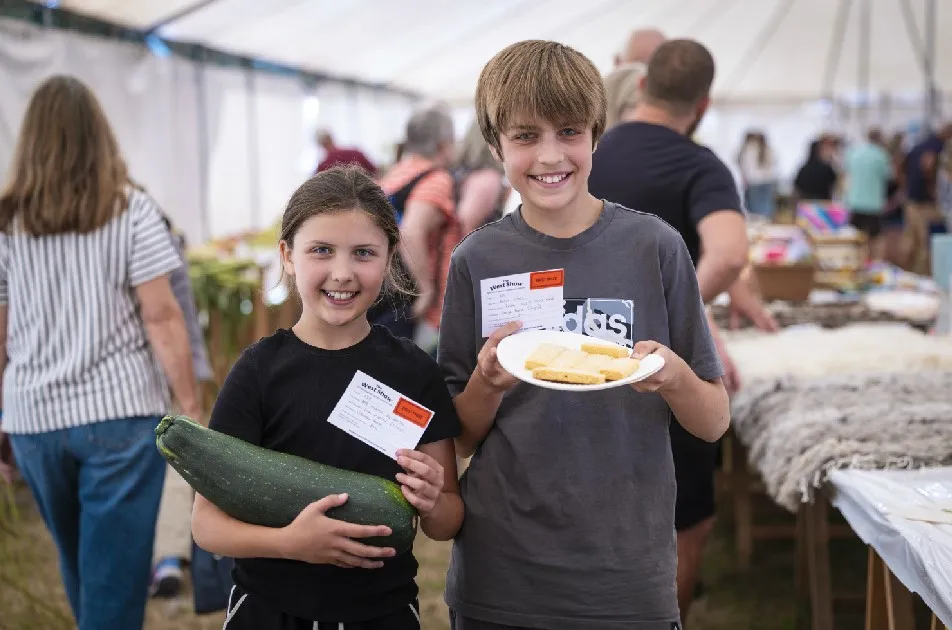 Charlotte, nine, with her winning marrow 7-10 years, and George Pearce, 12, with his winning shortbread in the adult class.