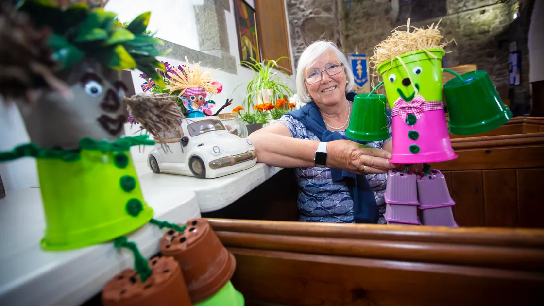 Barbara Martin with her flower pot-themed displays which are among those on display at the Vale Church over the weekend. (Picture by Peter Frankland, 30989549)