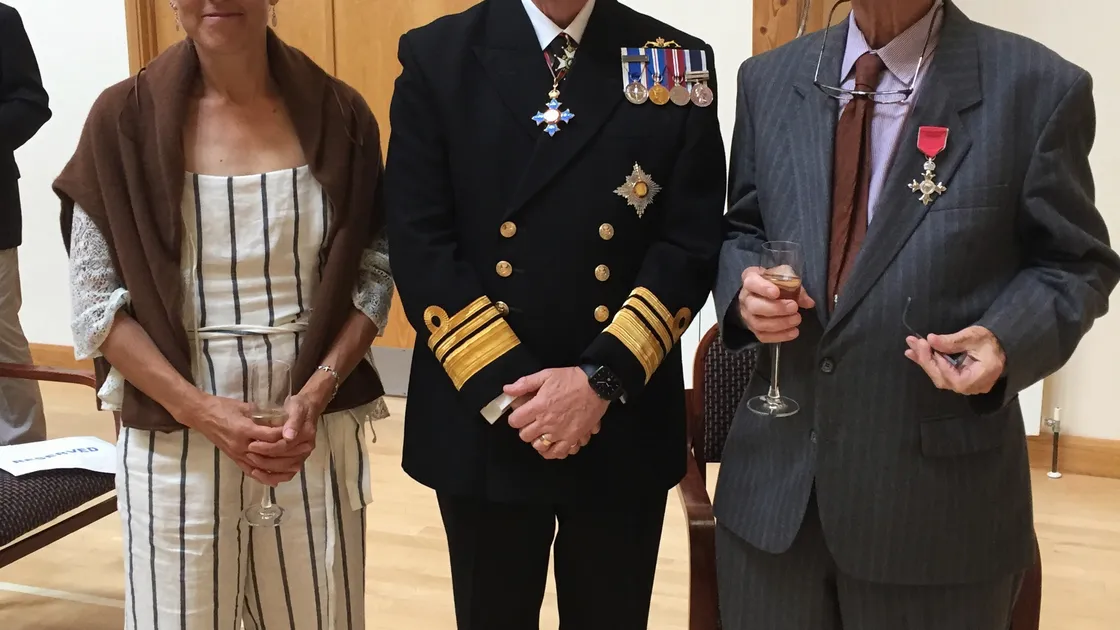 Dr Richard Axton receives his MBE from Lt-Governor Vice Admiral Sir Ian Corder. Also pictured is Lucy Axton. (29740595)