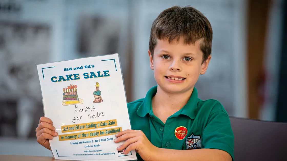 Seven-year-old twins Ed and Sid Robilliard have arranged a cake sale in memory of their father James, above, who passed away from a brain tumour in August of this year. They want to raise funds and awareness of the illness. Sid is pictured. (Picture by Peter Frankland, 33701264)