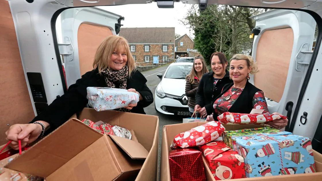 Getting ready to deliver Christmas presents to islanders who receive care at home are, left to right, Michele Simon, Haley Philips, Emma Bienvenu and Donna Edwards. (Picture by Steve Sarre, 20142848)