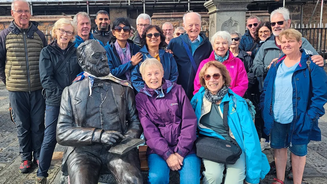 Visitors grab a snap with Victor Hugo on one of Soo Wellfair’s St Peter Port town tours this summer