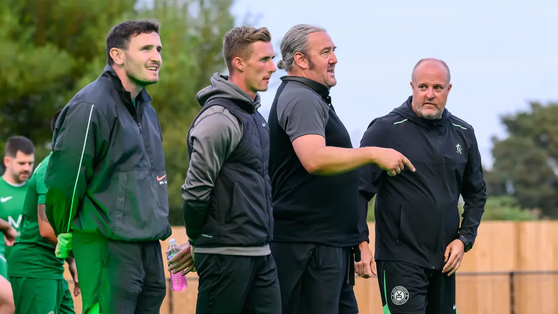 Vale Rec head coach Mark Romeril, far right, listens to an observation from his assistant Malcolm Symons during the Spirit Cup