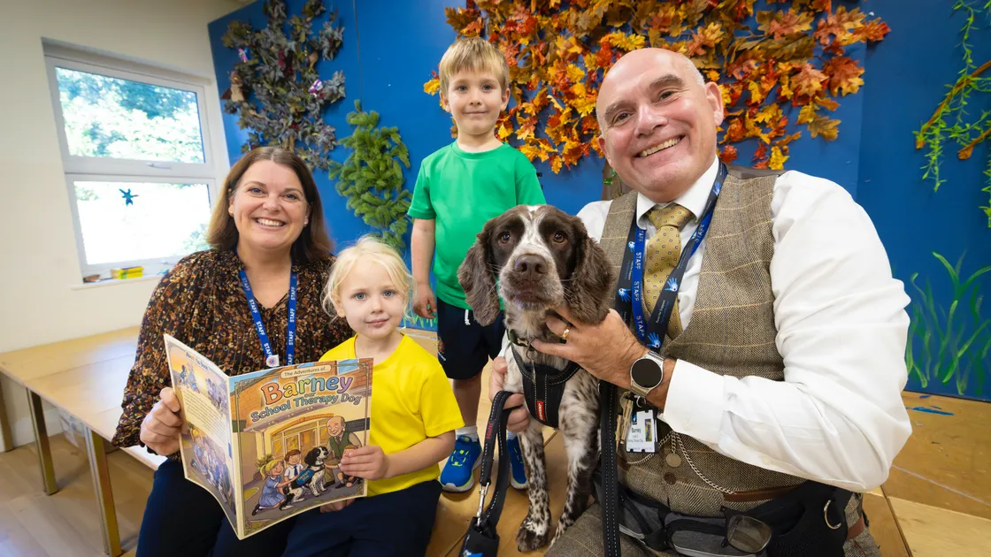 Barney the therapy dog visits Acorn House to listen to a new book written all about him.left to right, reception teacher Lisa Du Port, reception pupils Cassidy Woodruff and Rupert Lewis, and Elizabeth College Junior School head Richard Fyfe.