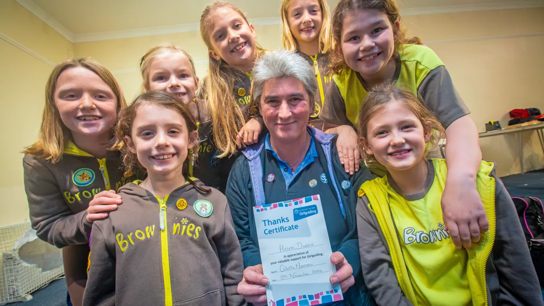 Helen Durkin has received an award for her 25 years of service at the 20th Guernsey St Saviour’s Brownies. With her are, left to right, front, Sophie Wilkins and Honor Duquemin, back, Clara Edwards, Florence Ozanne, Hattie Gabb, Olivier Ozanne and Briony-Rae Domaille. (Picture by Peter Frankland, 33779923)