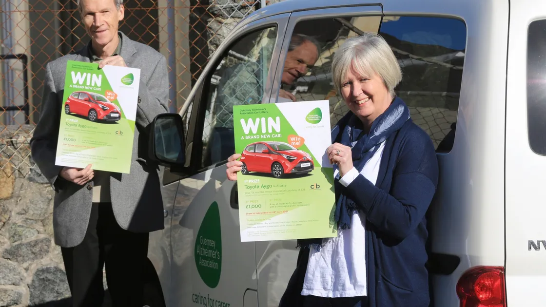 Guernsey Alzheimers Association chairman Stephen Collas and manager Julie Thompson with the posters about the launch of the charity's first ever car lottery. (Picture by Adrian Miller, 29283372)