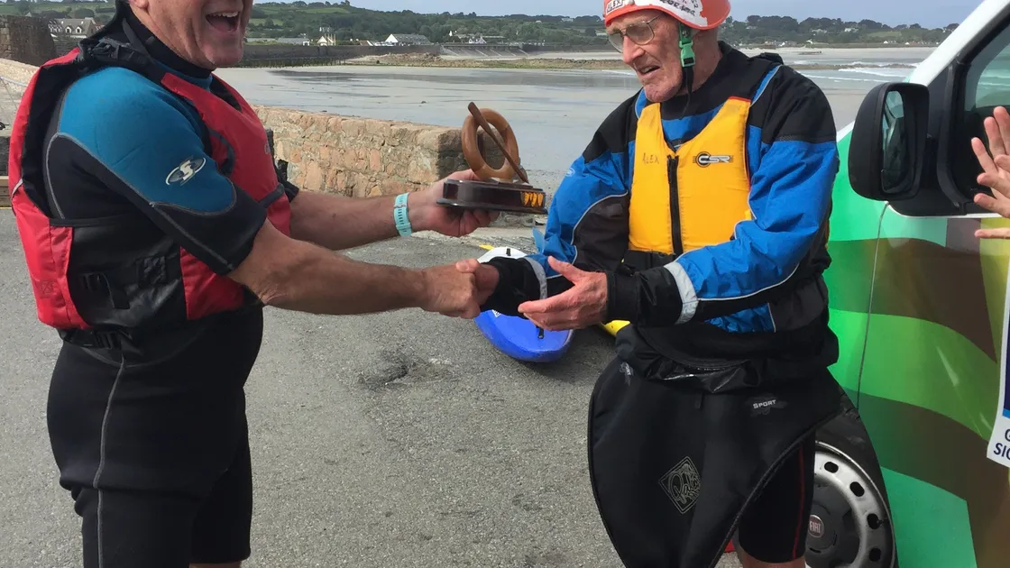 Brian Aplin, president of the Guernsey branch of the Royal Life Saving Society, presents Alex Allan, right, with the Brian Hockey Award.