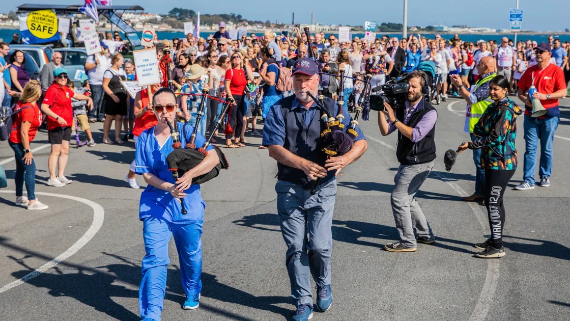 Bagpipe players Mary Murray and Kevin McLagan led the march.