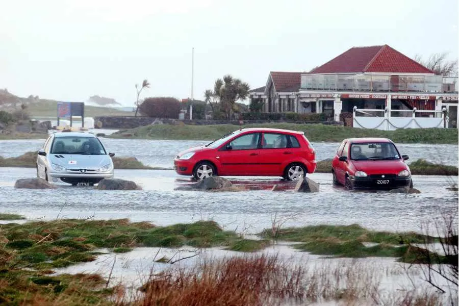 The car park by Crabby Jacks restaurant flooded again as waves poured over the coastal wall this morning. Picture by Tom Tardif.