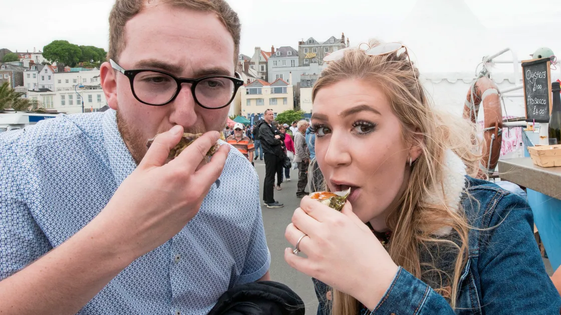 James Gillingham and his fiancee Eloise Maunder, who came ashore from the cruise ship Britannia, trying local oysters. (Pictures by Adrian Miller, 24823774)
