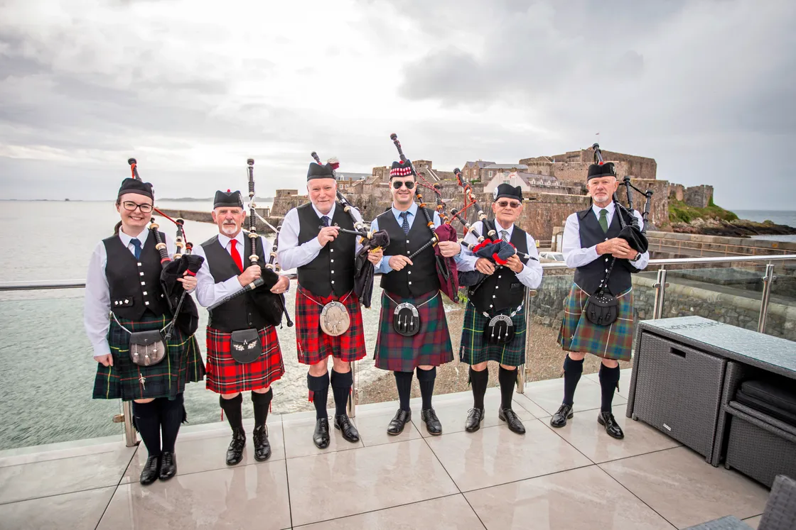 The group of local pipers on the balcony of the Guernsey Yacht Club yesterday morning. (Picture by Sophie Rabey, 33269837)