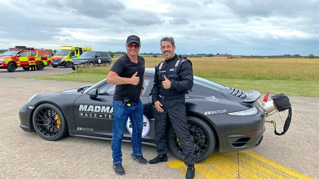 Zef Eisenberg (right) with his Porsche 911 at the VMax200 event.. (28507099)