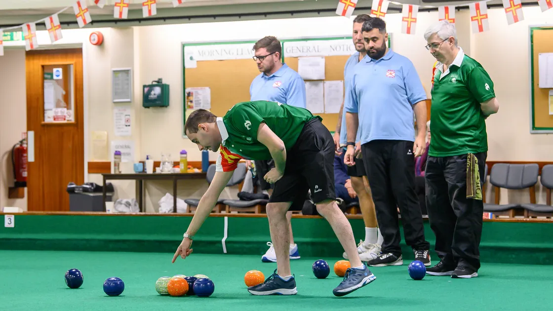 Josh Bonsall passes on some information to his skip Ian Merrien in the men’s triples final